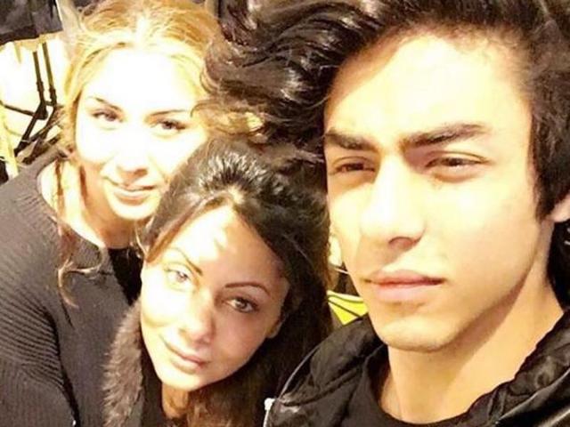 Mom Gauri is looking where? In the camera. Pretty blonde lady is looking where? In the camera. But Aryan? Where are your eyes at Aryan? (Instagram) 