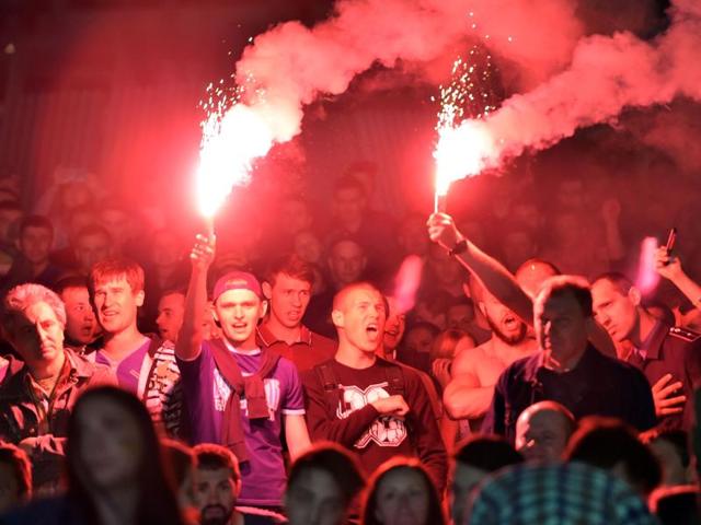 Ukrainian fans holding smoke bobs react as they watch the Euro 2016 group C football match Germany vs Ukraine on a giant screen in the fan zone in the center of Kiev. (AFP Photo) Ukrainian fans holding smoke bobs react as they watch the Euro 2016 group C football match Germany vs Ukraine on a giant screen in the fan zone in the center of Kiev. (AFP Photo)
