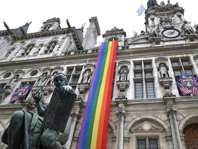 American flags and a rainbow banner hang at the Paris City Hall Monday, June 13, 2016 in Paris. (AP Photo) American flags and a rainbow banner hang at the Paris City Hall Monday, June 13, 2016 in Paris. (AP Photo)