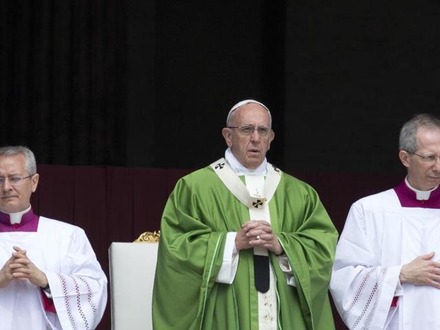 Maurice Forbes (Centre) holds a candle with others during a vigil for the victims of the Orlando shooting, Sunday, June 12, 2016, in Las Vegas. Pope Francis has expressed horror and condemnation over the shooting that killed at lease 50 people.(AP)