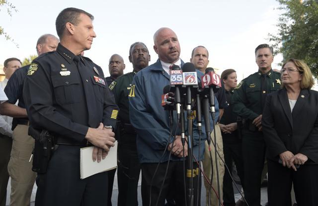 FBI assistant special agent in charge Ron Hopper, centre, answers questions from members of the media after a fatal shooting at Pulse Orlando nightclub. (AP) FBI assistant special agent in charge Ron Hopper, centre, answers questions from members of the media after a fatal shooting at Pulse Orlando nightclub. (AP)