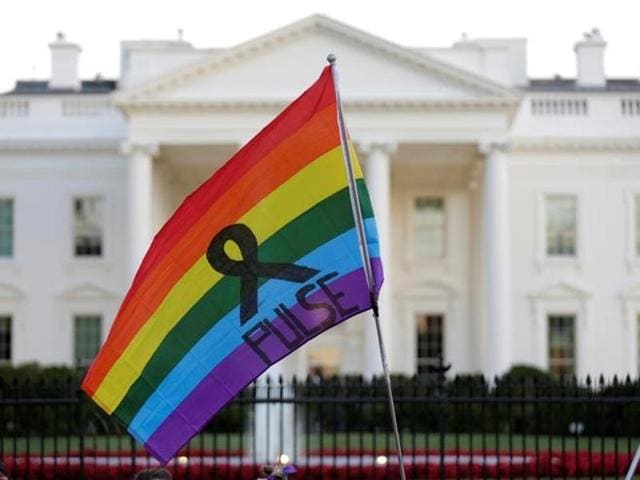 John Becker, centre, speaks to fellow members and supporters of the LGBT as they gather for a candlelight vigil in front of the White House in Washington on Sunday to remember the victims killed in the Orlando nightclub shooting.(AP)