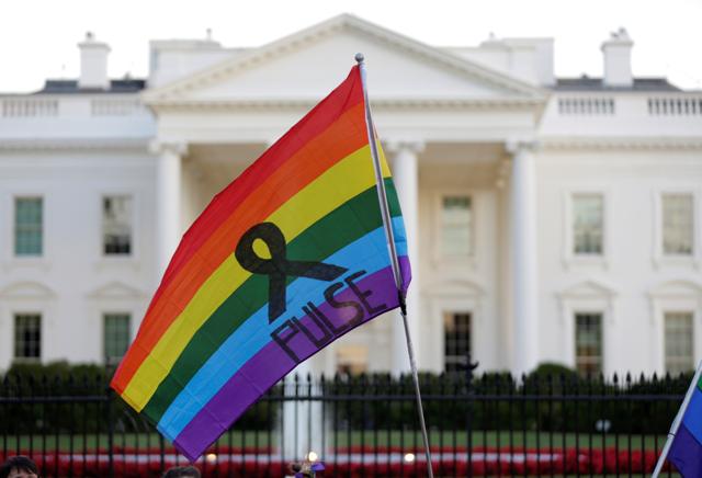 A rainbow flag is held up with the name of the gay nightclub where the worst mass shooting in US history occured in Orlando,Florida, during a vigil in front of the White House in Washington. (REUTERS) A rainbow flag is held up with the name of the gay nightclub where the worst mass shooting in US history occured in Orlando,Florida, during a vigil in front of the White House in Washington. (REUTERS)