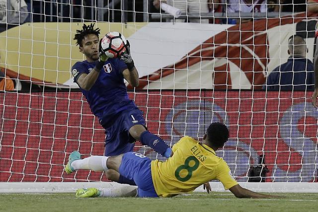 Peru’s goalkeeper Pedro Gallese makes a save in front of Brazil's Elias (8) during the second half of a Copa America Group B match. (AP Photo)