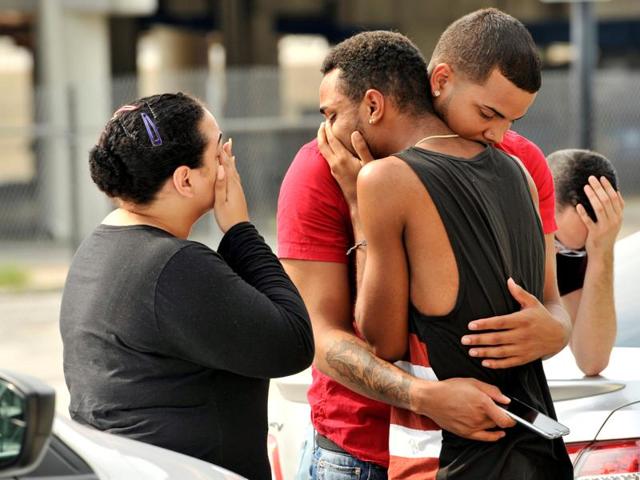 Friends and family members embrace outside the Orlando Police Headquarters during the investigation of a shooting at the Pulse night club.(Reuters Photo)