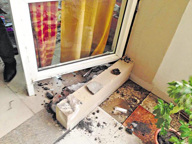 Residents alleged that doors broke, window panes shattered and cracks appeared on walls during a storm on Friday. (HT Photo) Residents alleged that doors broke, window panes shattered and cracks appeared on walls during a storm on Friday. (HT Photo)