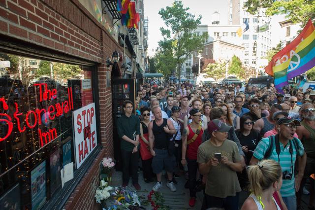 People gather during a vigil in reaction to the mass shooting at a gay nightclub in Orlando. (AFP)