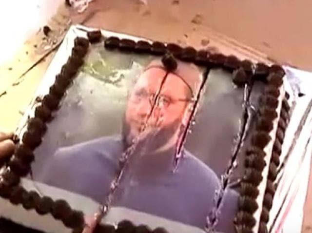The cake with Owaisi’s image on it was cut by some of MNS supporters in the residence. (Video grab) The cake with Owaisi’s image on it was cut by some of MNS supporters in the residence. (Video grab)