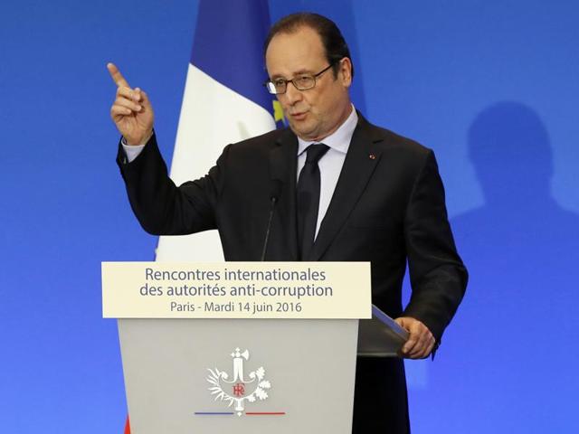 French President Francois Hollande held an emergency security meeting about what he said was "incontestably a terrorist act" after a Frenchman killed two police officials Monday night in a Paris suburb.(AP Photo)