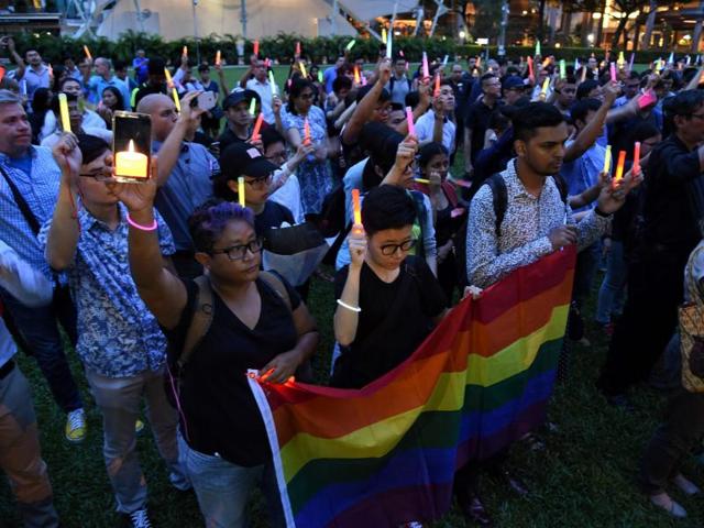 People join a vigil for the victims of the Orlando shooting in Florida, in Singapore on June 14, 2016.(AFP Photo) People join a vigil for the victims of the Orlando shooting in Florida, in Singapore on June 14, 2016.(AFP Photo)
