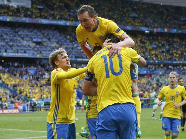 Sweden's Zlatan Ibrahimovic, back to camera, celebrates with Kim Kallstrom, top, and teammates after Ireland's Ciaran Clark scored an own goal, during the Euro 2016 Group E match against Ireland at the Stade de France in Saint-Denis, north of Paris, on June 13, 2016. (AP)