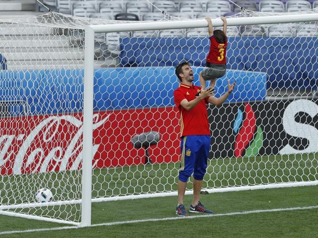 Gerard Pique plays on the pitch with his son Milan after the match. (AP)