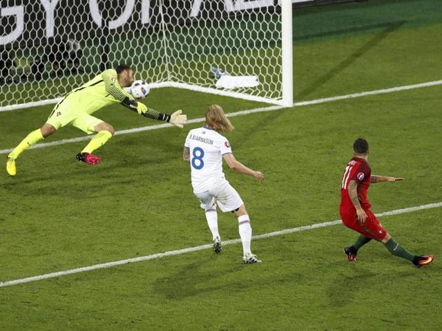Iceland's Birkir Bjarnason, centre, scores Iceland’s equaliser past Portugal goalkeeper Rui Patricio. (AP) Iceland's Birkir Bjarnason, centre, scores Iceland’s equaliser past Portugal goalkeeper Rui Patricio. (AP)