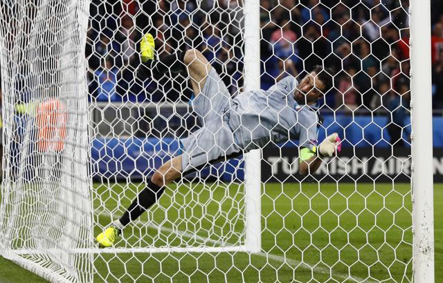 Italy ‘keeper Gianluigi Buffon was so happy with Italy’s win he charged out to the opposite goal, tried to swing off the crossbar in celebration, but slipped and fell. (REUTERS)