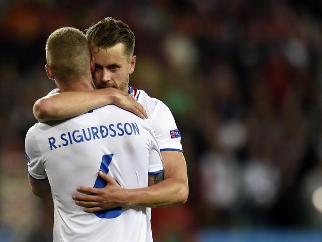 Iceland defenders Ragnar Sigurdsson (L) and Kari Arnason hug after the match. (AFP) Iceland defenders Ragnar Sigurdsson (L) and Kari Arnason hug after the match. (AFP)