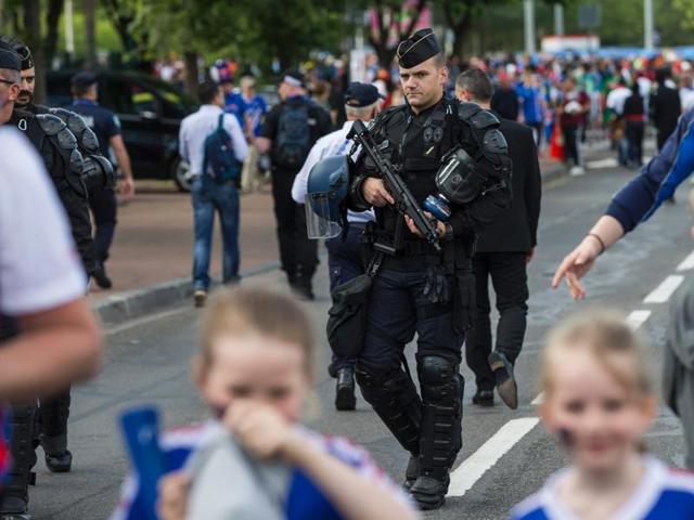 Police patrol the perimeter walking behind Icelandic football fans outside the Geoffroy-Guichard stadium in Saint-Etienne prior to the match between Portugal and Iceland. (AFP Photo)