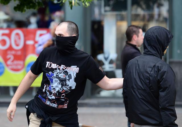 A Russian football fan taunts England fans (unseen) sitting in a cafe in the city of Lille on June 14, 2016, the day before the Euro 2016 group B match Russia vs Slovakia at the Pierre-Mauroy stadium. (AFP)