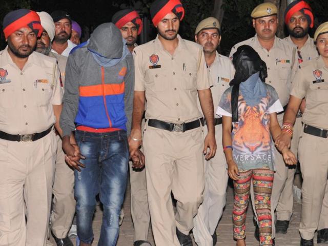Accused Agu Emmanuel, 32, and Okoh Precious, 20, in the Jalandhar police custody on Tuesday.(Pardeep Pandit/HT Photo)