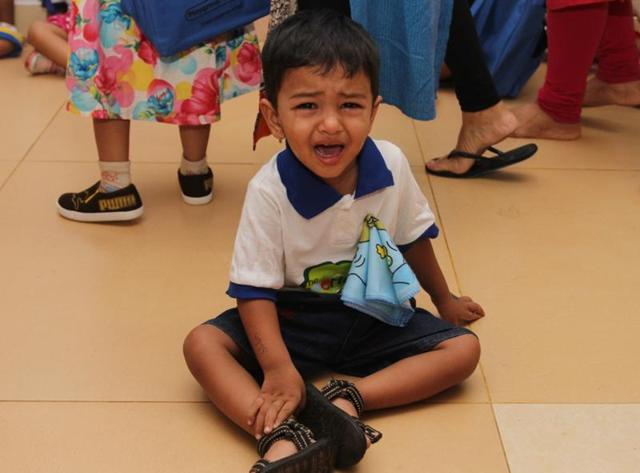 Not happy, will protest: This child made his displeasure clear by sitting on the floor. (PRAFUL GANGURDE) 