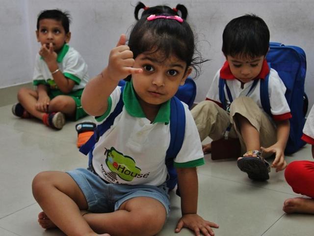 Bored with the goings on, this child chose to interact with the camera, instead of teachers and friends. (PRAFUL GANGURDE) 
