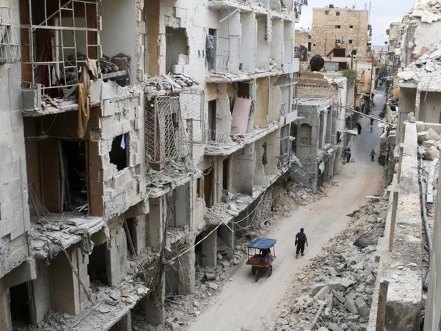 Residents walk near damaged buildings in the rebel held area of Old Aleppo, Syria, May 5, 2016. (Reuters) Residents walk near damaged buildings in the rebel held area of Old Aleppo, Syria, May 5, 2016. (Reuters)