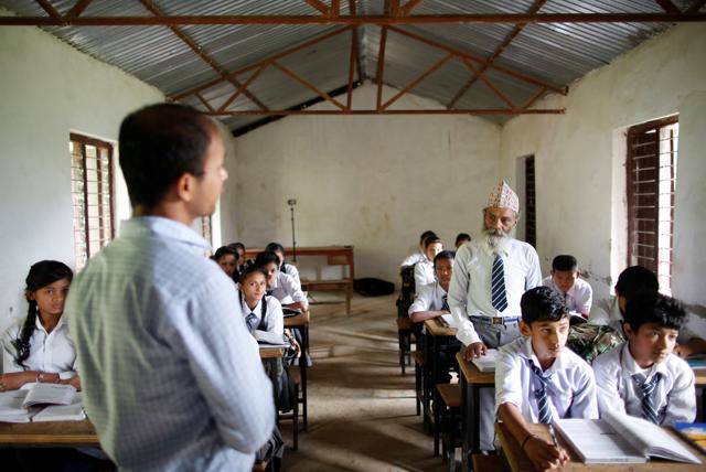 Durga Kami answers a question from his teacher as he attends a class. (REUTERS)