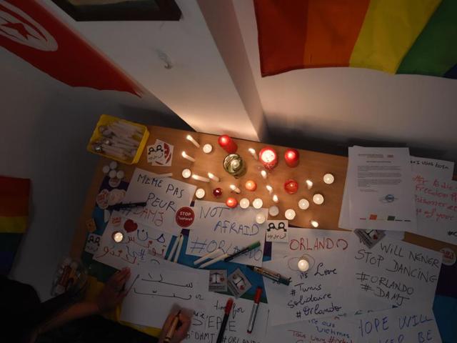 Tunisians belong to the Tunisian association for justice and equality light candles and write slogans in Tunis, in solidarity with the victims of the Orlando mass shooting. (AFP) Tunisians belong to the Tunisian association for justice and equality light candles and write slogans in Tunis, in solidarity with the victims of the Orlando mass shooting. (AFP)