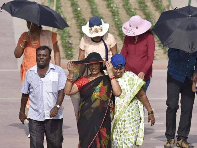 Visitors at Rajghat, New Delhi, try to cover themselves to avoid the heat wave as Delhi/NCR experienced yet another scorching day, May 22, 2016. May has been declared the hottest spring on record by NASA. (Sanjeev Verma / HT Photo) Visitors at Rajghat, New Delhi, try to cover themselves to avoid the heat wave as Delhi/NCR experienced yet another scorching day, May 22, 2016. May has been declared the hottest spring on record by NASA. (Sanjeev Verma / HT Photo)