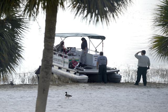 Law enforcement officials search the Seven Seas Lagoon outside the Grand Floridian Resort & Spa on Wednesday. (AP) Law enforcement officials search the Seven Seas Lagoon outside the Grand Floridian Resort & Spa on Wednesday. (AP)