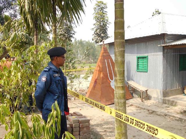 In this file photo, a Bangladeshi policeman stands guard where a top Hindu priest was killed in the remote northern district of Panchagarh.(AFP) In this file photo, a Bangladeshi policeman stands guard where a top Hindu priest was killed in the remote northern district of Panchagarh.(AFP)