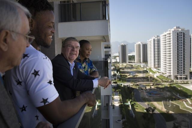 IOC president Thomas Bach (centre) talks with refugees and judo athletes from the Democratic Republic of Congo Yolande Mabika (right) and Popole Misenga as they visit an apartment at the Olympic Village in Rio de Janeiro, Brazil. (AP Photo)