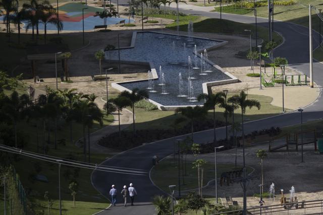 People walk after the opening ceremony of the Olympic Village in Rio de Janeiro, Brazil. (AP Photo)