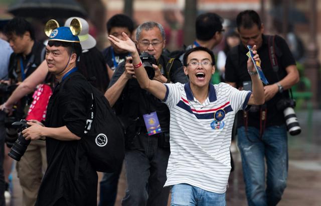 The first visitor reacts as he enters the Shanghai Disney Resort. (AFP)