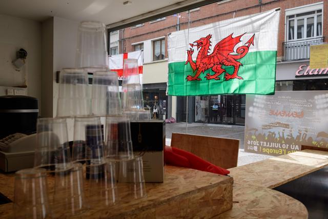 English (left) and Welsh (right) flags are pictured in a pop-up food and beer store window in Lens, in northern France. (AFP Photo) English (left) and Welsh (right) flags are pictured in a pop-up food and beer store window in Lens, in northern France. (AFP Photo)