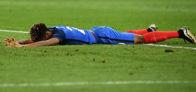 France's forward Kingsley Coman lies on the pitch. (AFP) France's forward Kingsley Coman lies on the pitch. (AFP)