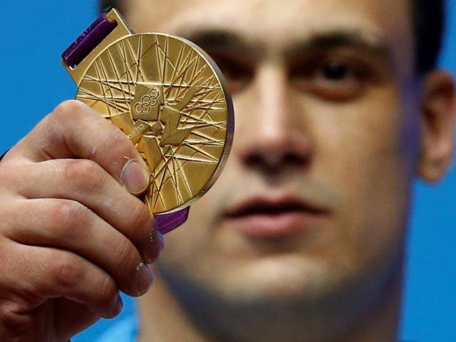 Kazakhstan's Ilya Ilyin poses with his gold medal of the men's 94kg weightlifting competition at the ExCel venue at the London 2012 Olympic Games. Kazakhstan's Ilya Ilyin poses with his gold medal of the men's 94kg weightlifting competition at the ExCel venue at the London 2012 Olympic Games.