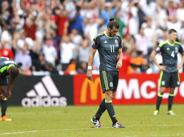 Wales' Gareth Bale, centre, looks dejected after his side’s 1-2 defeat. (AP)