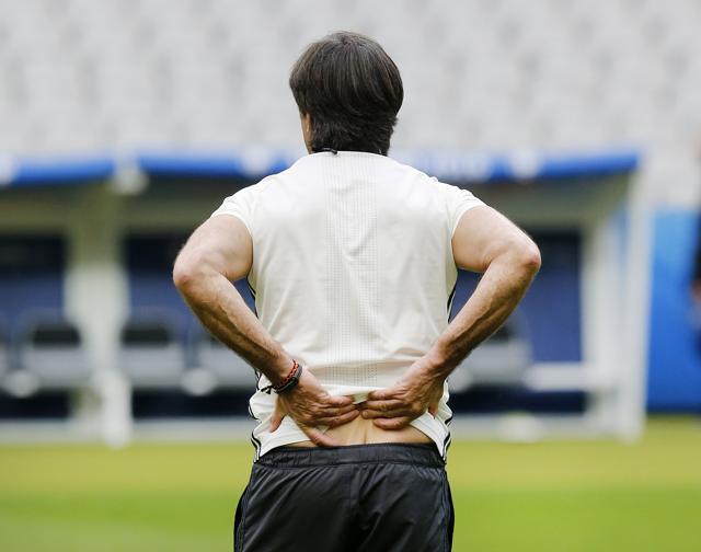 Coach Joachim Loew holds his back during a training session of the German national soccer team in Saint-Denis, France on Wednesday. (AP) Coach Joachim Loew holds his back during a training session of the German national soccer team in Saint-Denis, France on Wednesday. (AP)