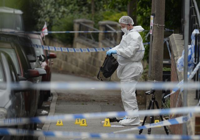 A police forensic officer picks up a bag from the crime scene where Labour MP Jo Cox was shot in Birstall, northern England on Thursday (AFP) A police forensic officer picks up a bag from the crime scene where Labour MP Jo Cox was shot in Birstall, northern England on Thursday (AFP)
