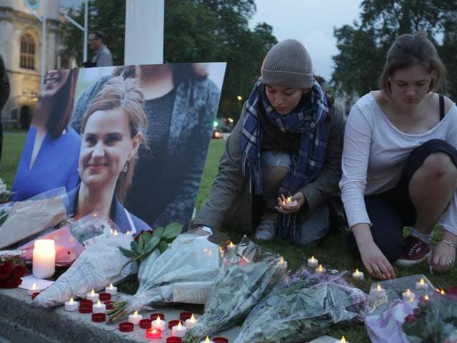 Floral tributes and candles are placed by a picture of slain Labour MP Jo Cox at a vigil in Parliament square in London on June 16, 2016. (AFP) Floral tributes and candles are placed by a picture of slain Labour MP Jo Cox at a vigil in Parliament square in London on June 16, 2016. (AFP)
