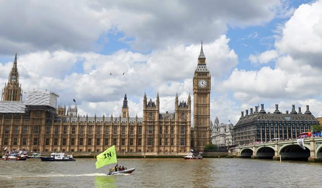 A boat flying a large "In" flag sails by the British Houses of Parliament to oppose a flotilla of boats from the group 'Fishing for Leave' (L) on the river Thames in London. (AFP) A boat flying a large "In" flag sails by the British Houses of Parliament to oppose a flotilla of boats from the group 'Fishing for Leave' (L) on the river Thames in London. (AFP)