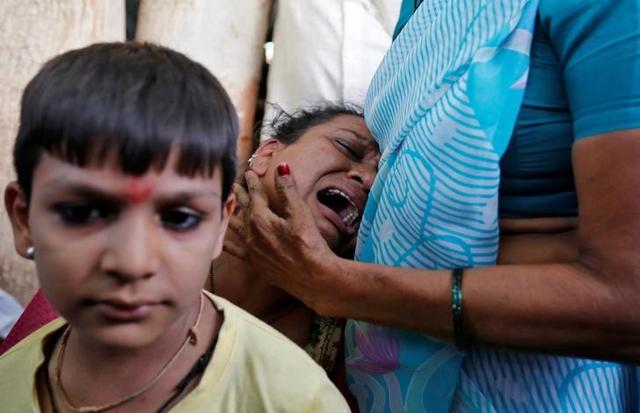 A relative of the convicted in connection with a riot in Gujarat in 2002, is consoled as she cries outside a court during a hearing in Ahmedabad. (reuters)