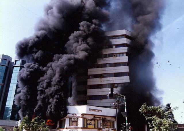 File photo of a bomb blast near a building during 2002 Gujarat riots. (PTI Photo) File photo of a bomb blast near a building during 2002 Gujarat riots. (PTI Photo)