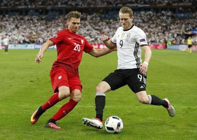 Germany's Andre Schurrle in action with Poland's Lukasz Piszczek. (Reuters Photo) Germany's Andre Schurrle in action with Poland's Lukasz Piszczek. (Reuters Photo)