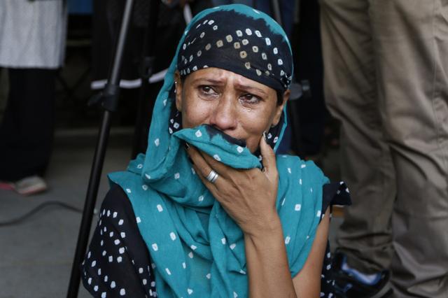 A relative of a convict in the 2002 Gujarat riots case cries after the court announced the lengths of the sentences in Ahmadabad. (AP)