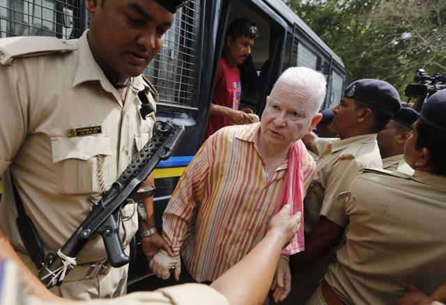 A person convicted on charges from the 2002 Gujarat riots is brought to court in Ahmadabad. (AP)
