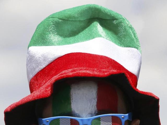 An Italy fan heads to the stadium in Toulouse for the Group E game against Sweden. (Reuters Photo)