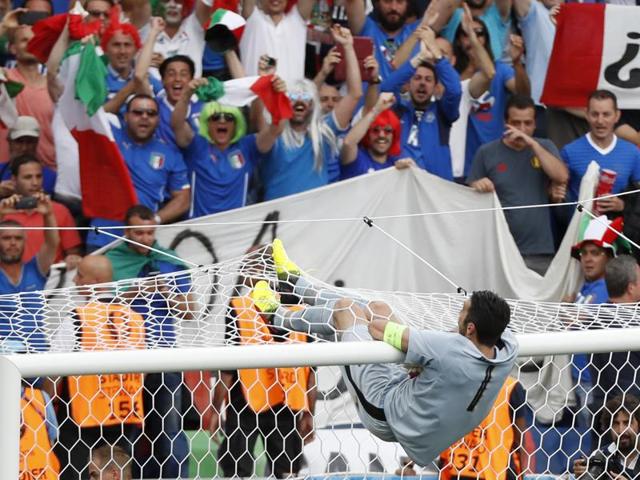 Italy's Gianluigi Buffon celebrates on the cross bar after the match. (Reuters Photo)