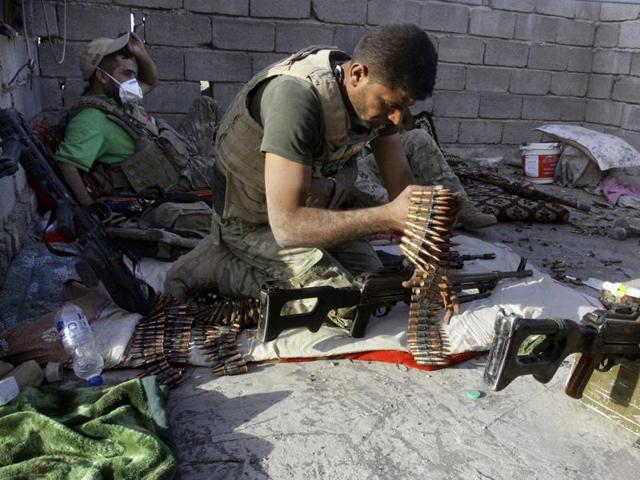 An Iraqi soldier assembles his weapons during clashes in Fallujah, Iraq. Fallujah has been locked in a cycle of conflict since 2003, when it emerged as a bastion of the insurgency against the Americans. (AP) An Iraqi soldier assembles his weapons during clashes in Fallujah, Iraq. Fallujah has been locked in a cycle of conflict since 2003, when it emerged as a bastion of the insurgency against the Americans. (AP)