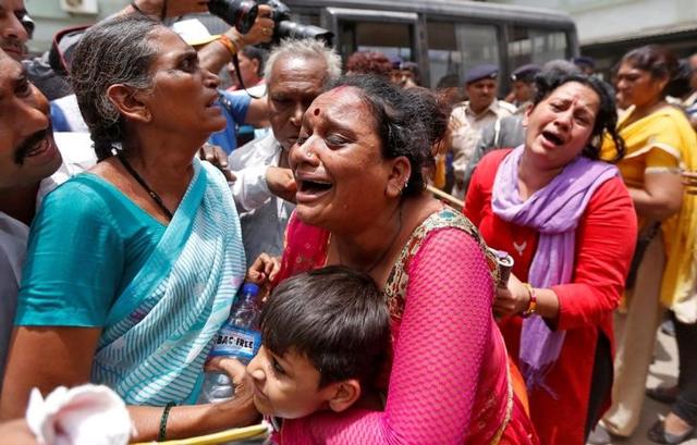 Relatives of those convicted in connection with a riot in Gujarat in 2002, cry outside a court after the sentencing in Ahmedabad. (reuters)